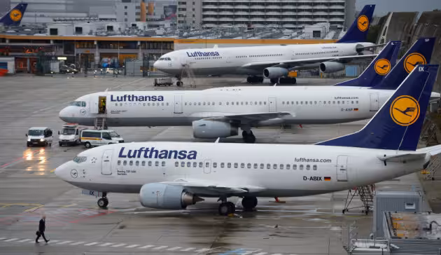 FRANKFURT AM MAIN, GERMANY - OCTOBER 21: A man walkes in front of Lufthansa airplanes at the Frankfurt Airport on October 21, 2014 in Frankfurt am Main, Germany. Vereinigung Cockpit, the labor union that represents the pilots, launched the two-day strike yesterday that has been expanded from short and medium-distance flights on the first day to long haul flights today, affecting over 100,000 passengers. This is the seventh strike by Lufthansa and Germanwings (a Lufthansa subsidiary) pilots this year as the union attempts to maintain the Lufthansa pilots' early retirement guarantee, a benefit that Lufthansa is trying to cut. (Photo by Thomas Lohnes/Getty Images)
