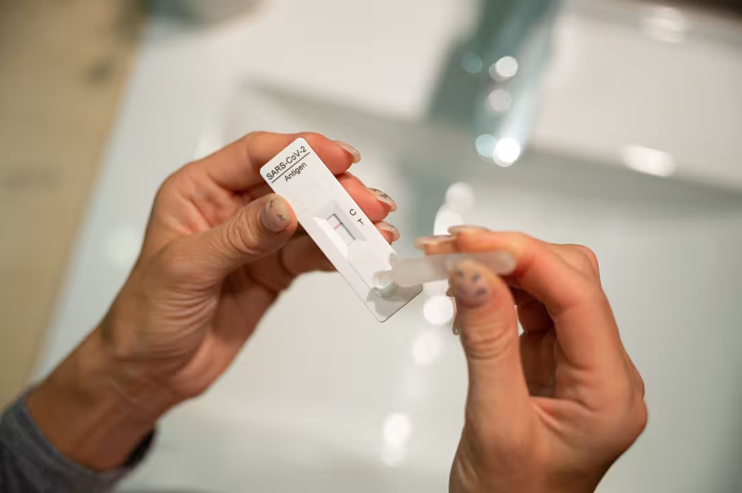 Dropping a sample solution on home self covid19 test stick.