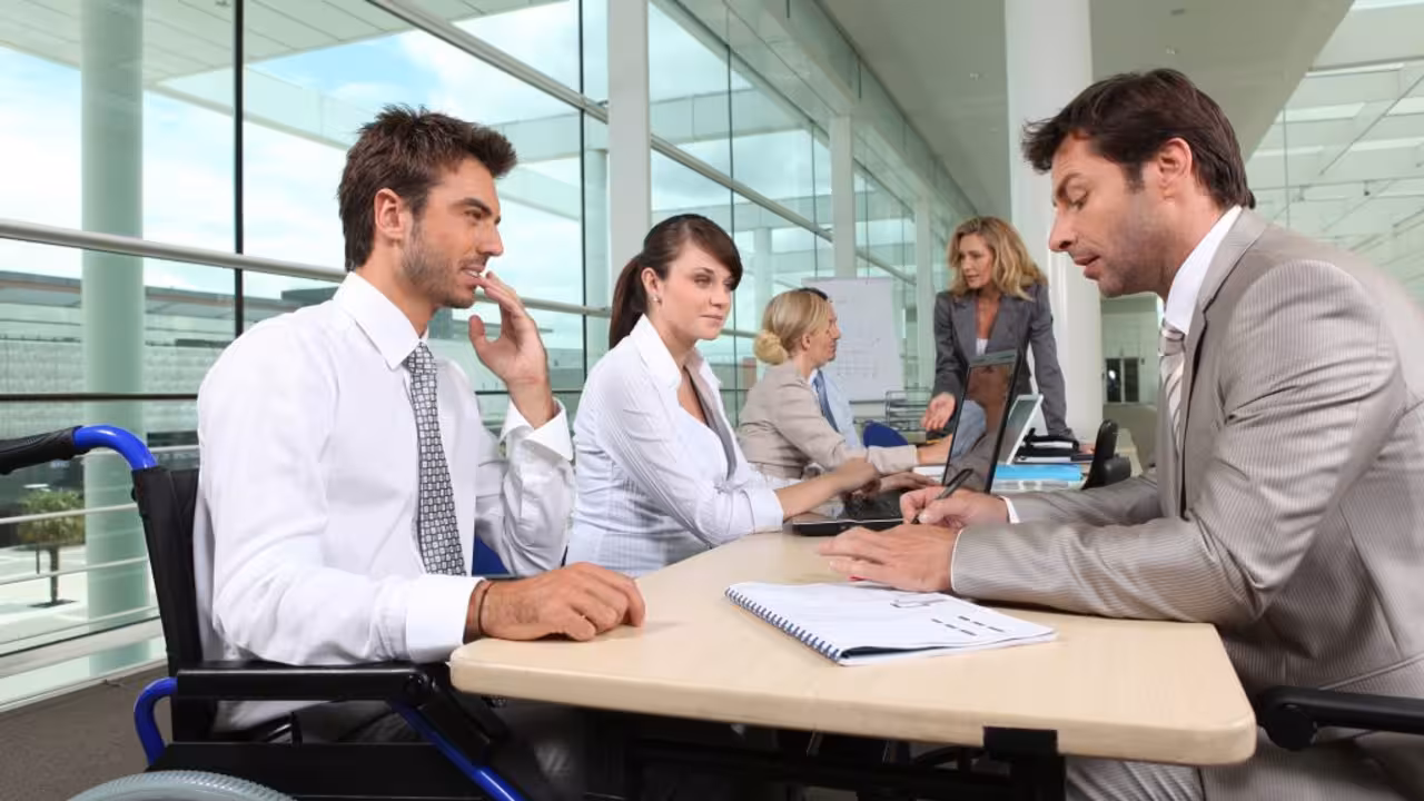 Man in wheelchair working in an office