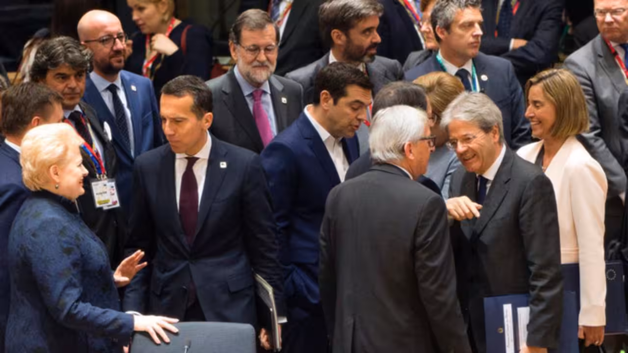 Italy's Prime minister Paolo Gentiloni (2nd R) speaks with European Commission President  Jean-Claude Juncker (3rd R) among EU leaders during a special EU leaders' meeting at the Europa building, the main headquarters of European Council and the Council of the EU, in Brussels, on April 29, 2017. The 27 ?EU leaders hold a summit to adopt Brexit negotiating guidelines. EU President Donald Tusk urged the bloc to keep a united front at a special Brexit summit in Brussels, saying it will also help Britain if they can reach a deal. / AFP PHOTO / POOL / Virginia Mayo