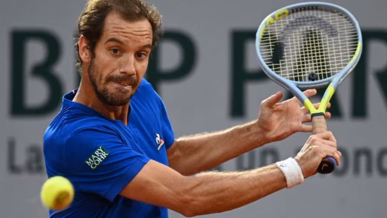 France's Richard Gasquet plays a backhand return to South Africa's Lloyd Harris during their men's singles match at the Court Suzanne-Lenglen on day two of the Roland-Garros Open tennis tournament in Paris on May 23, 2022. (Photo by Christophe ARCHAMBAULT / AFP)